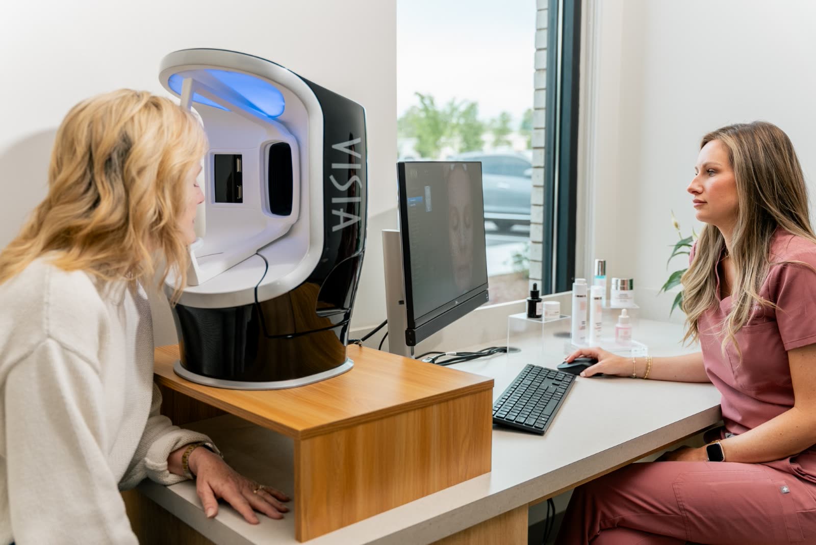 A guest in the Visia booth while the consulter works at the monitor beside it