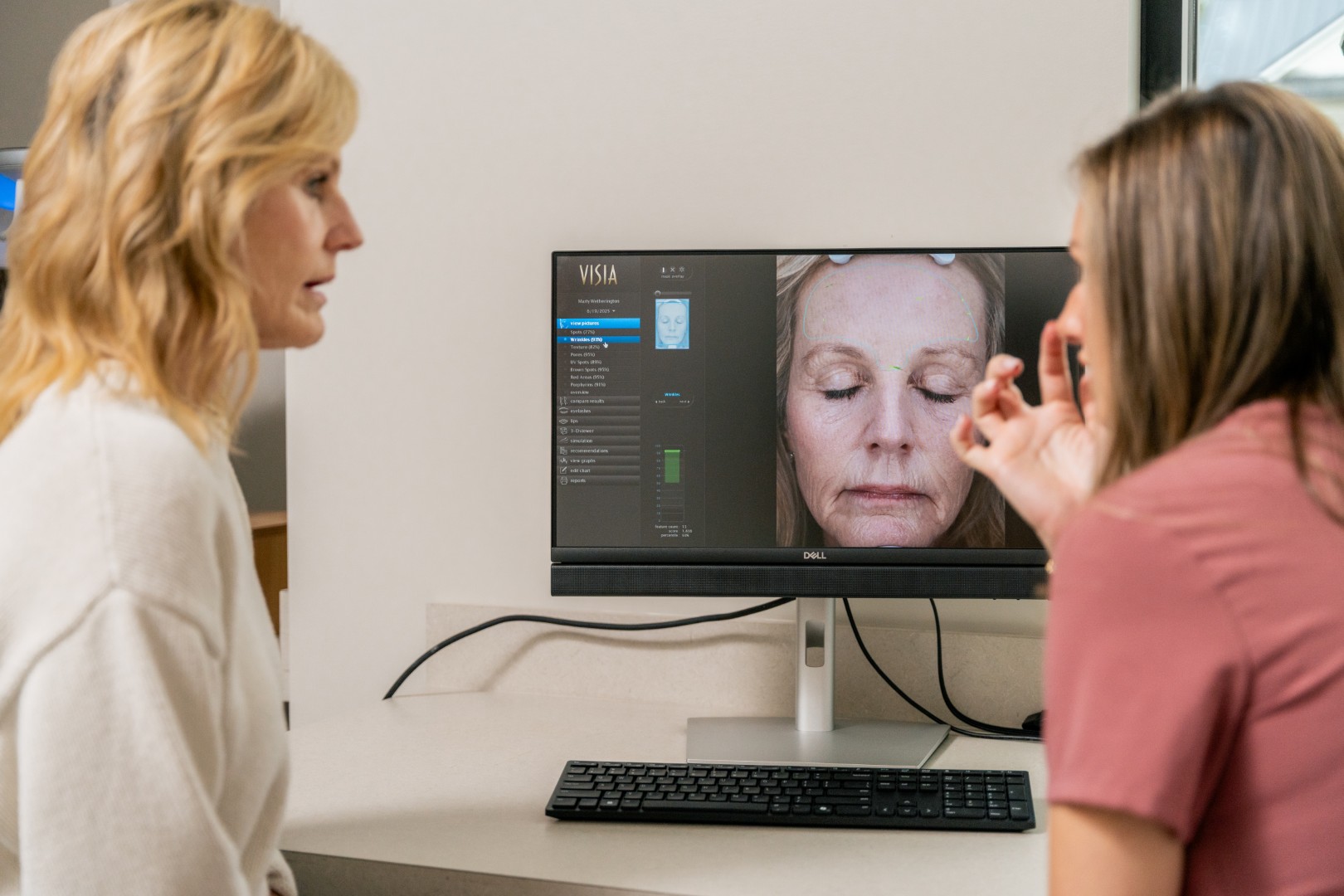 Provider reviewing Visia Skin Analysis results with a guest