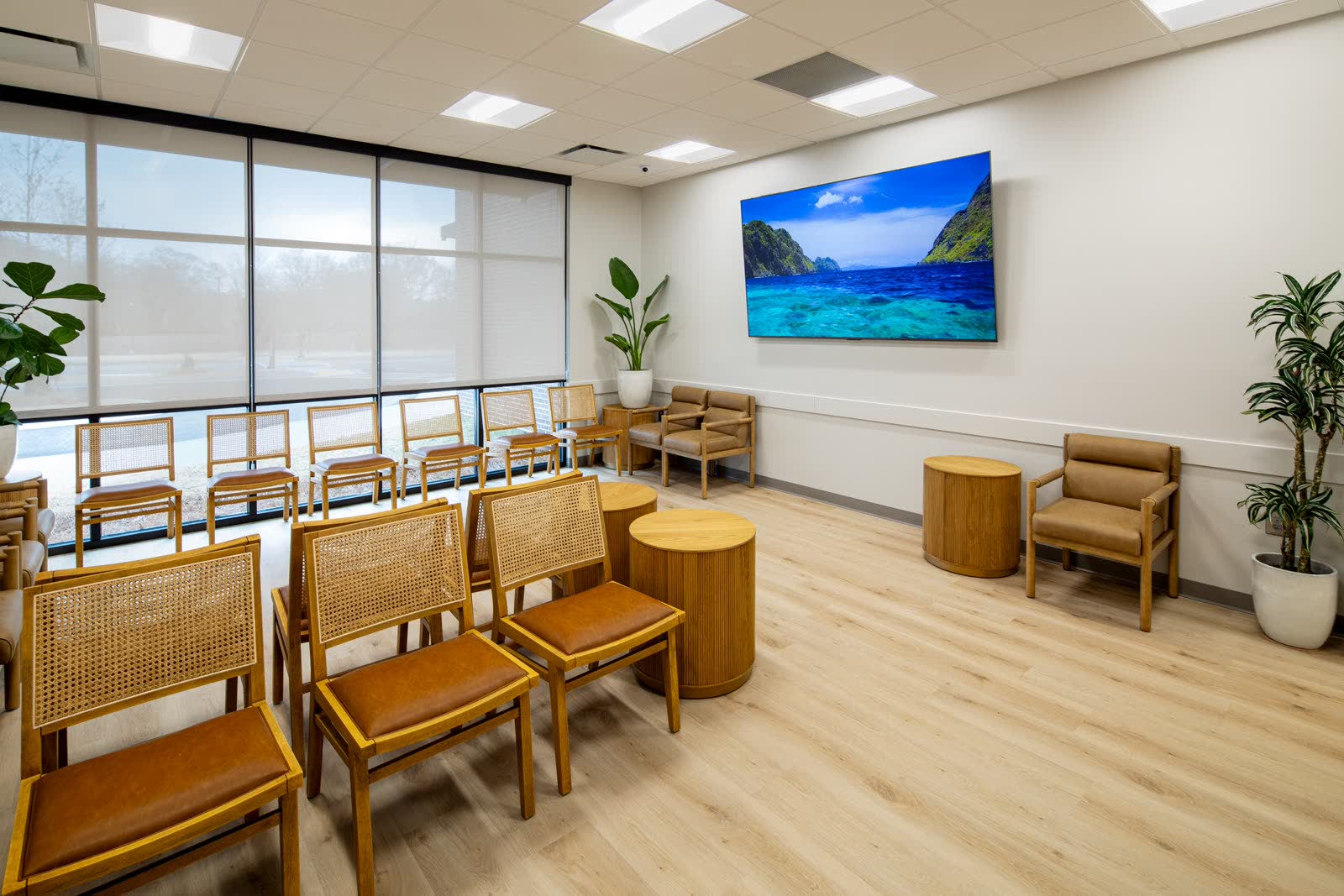The Carrollton waiting room with cane-back chairs and natural light, shared by West Georgia Dermatology and Carroll Cosmetic Club