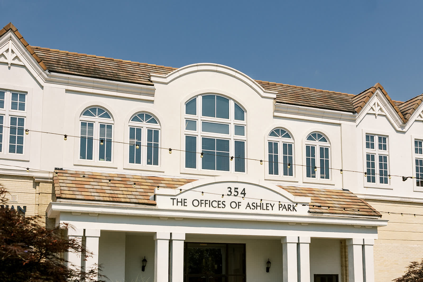 The sign reading 354 The Offices of Ashley Park above the building&rsquo;s columned entrance in Newnan