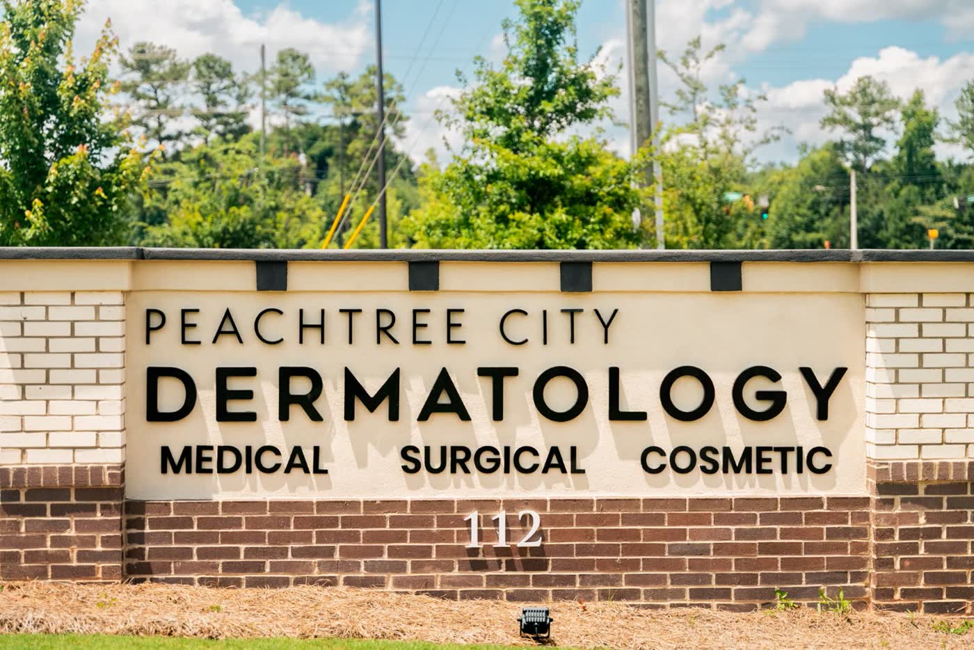 The Peachtree City Dermatology monument sign reading Medical, Surgical, Cosmetic. The cosmetic side is Carroll Cosmetic Club Peachtree City