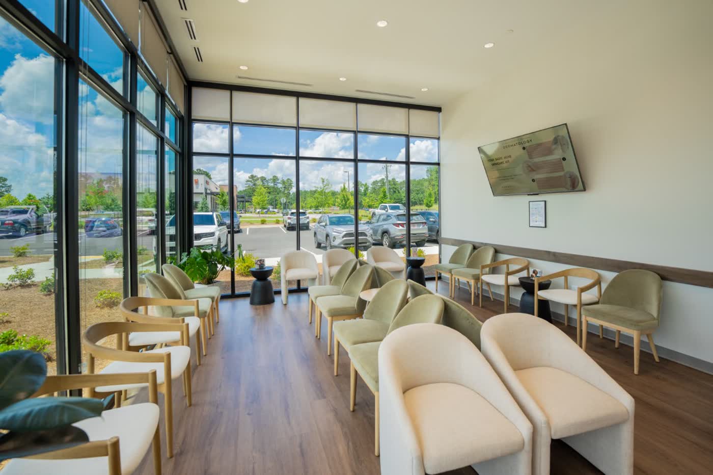 The Peachtree City waiting lounge with armchairs and natural light, shared by Peachtree City Dermatology and Carroll Cosmetic Club