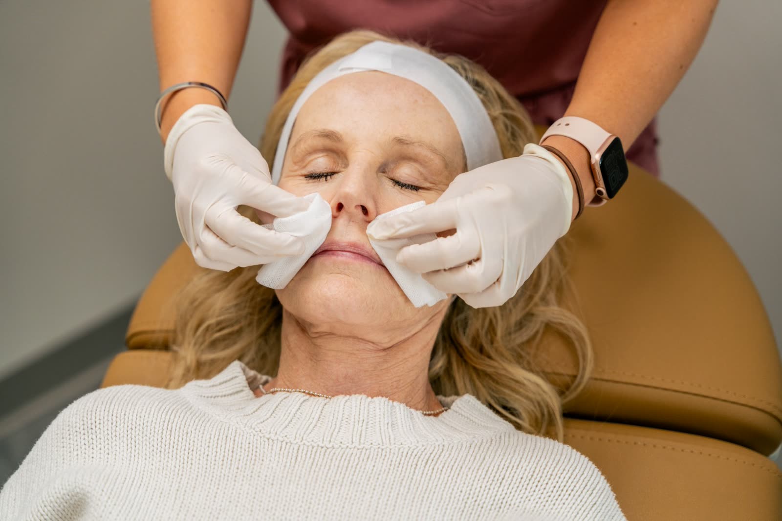 Provider applying solution to a guest's skin during a facial treatment