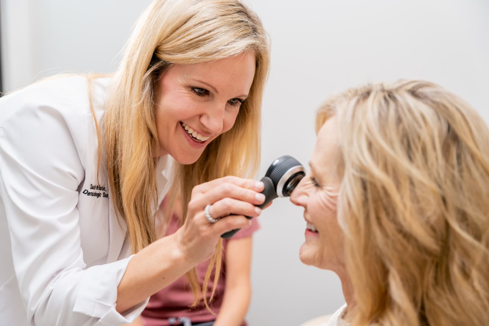 Dr. Sarah Wilson examining a guest's skin