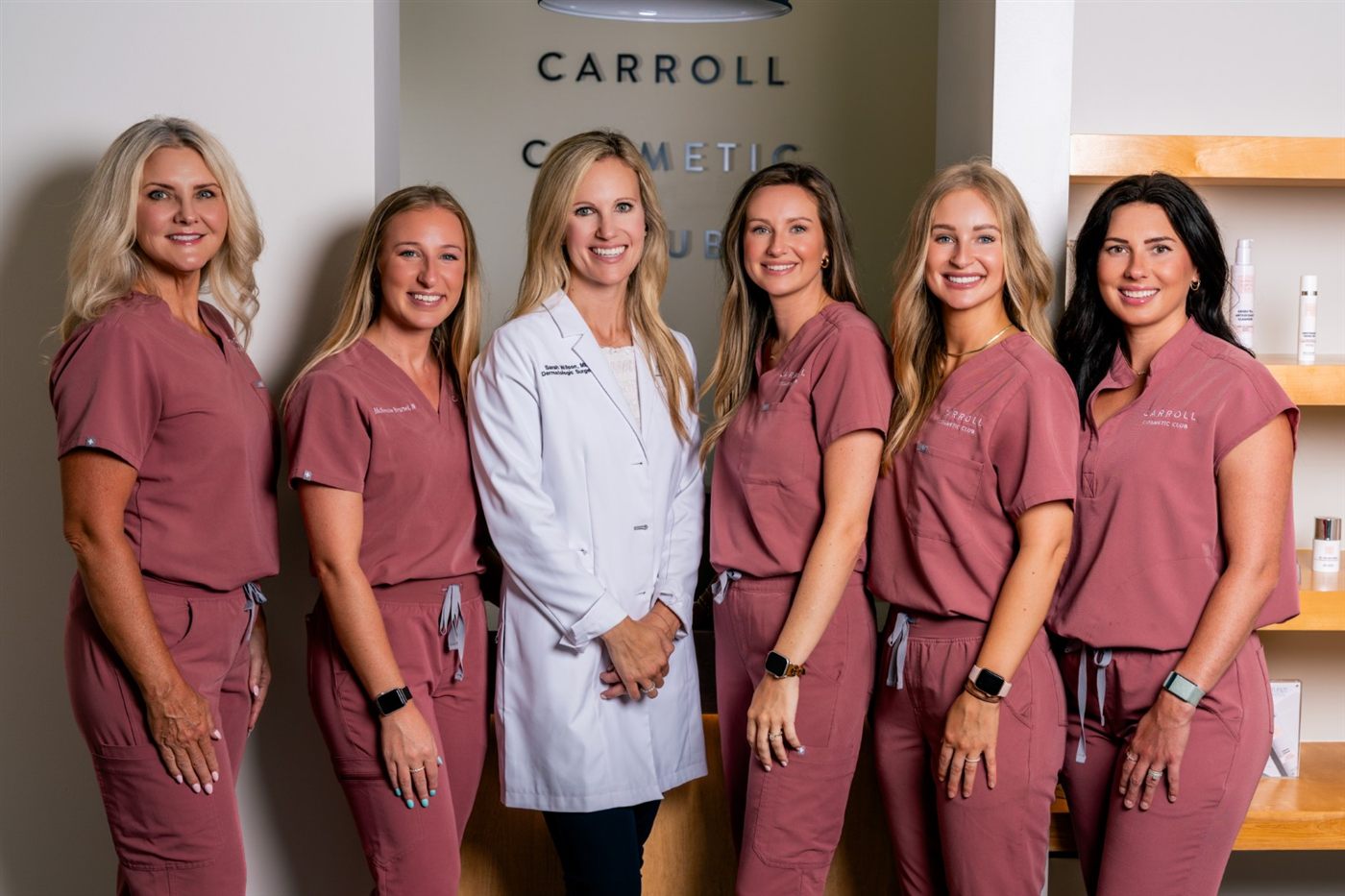 The Carroll Cosmetic Club team in the Peachtree City studio beside the skincare shelves